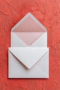 Elegant White and Pink Envelopes on Coral Background Royalty Free Stock Photo